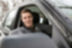 Man smiling in car window