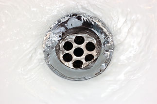 Close-up of basin drain with running water