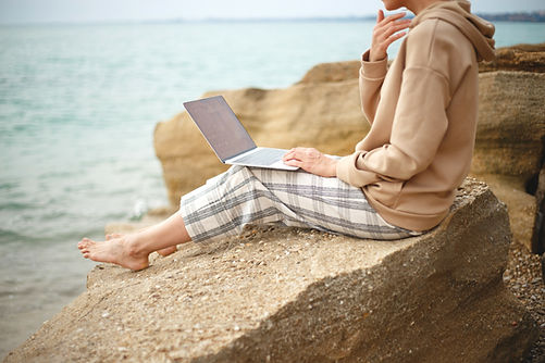 Woman by the sea symbolising calm and reflection during personal growth