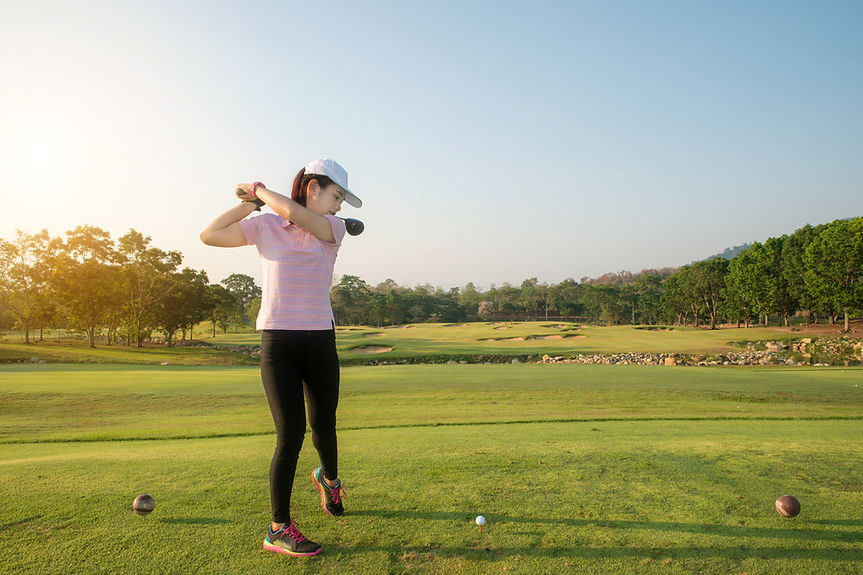 A woman playing golf
