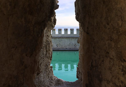 A gap between walls exposing a castle.