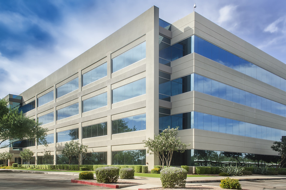 Modern multi-storey commercial office building with glass windows