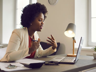 Woman speaking in front of a laptop computer
