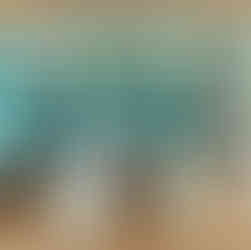 Exercise equipment in a gym looking over an indoor pool