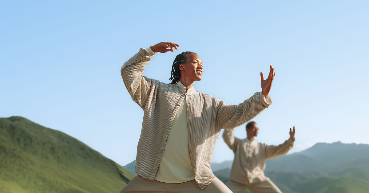 A small group of adults practising Tai Chi outdoors in a peaceful park, moving slowly and confidently together.