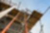 Looking up to construction site scaffolding with tied in ladder