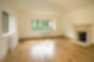 An empty room with a radiator and finished walls