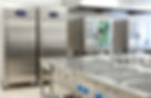 An empty restaurant kitchen with refrigeration