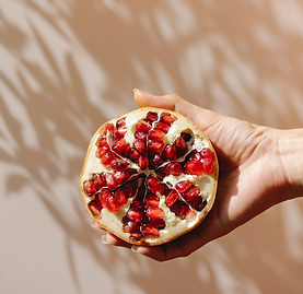 Hand Holding Pomegranate