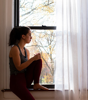 Woman Sitting By Window
