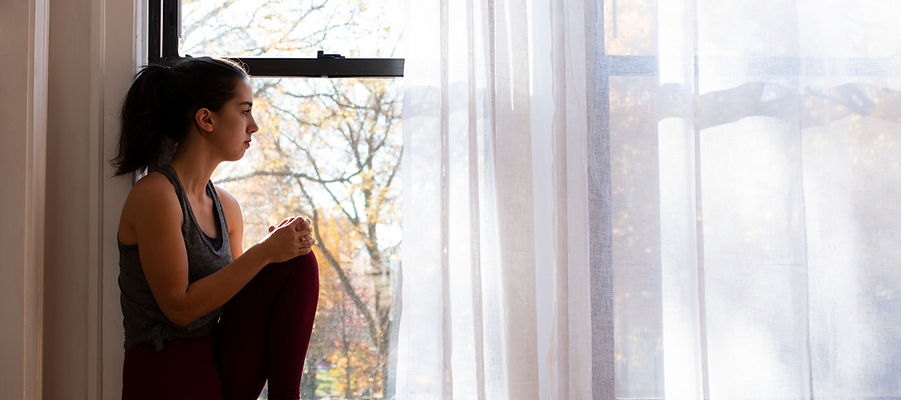 Woman Sitting By Window