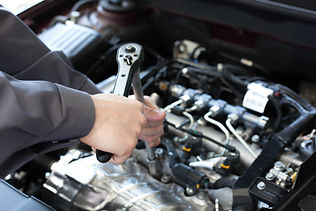 mechanic's hands with wrench