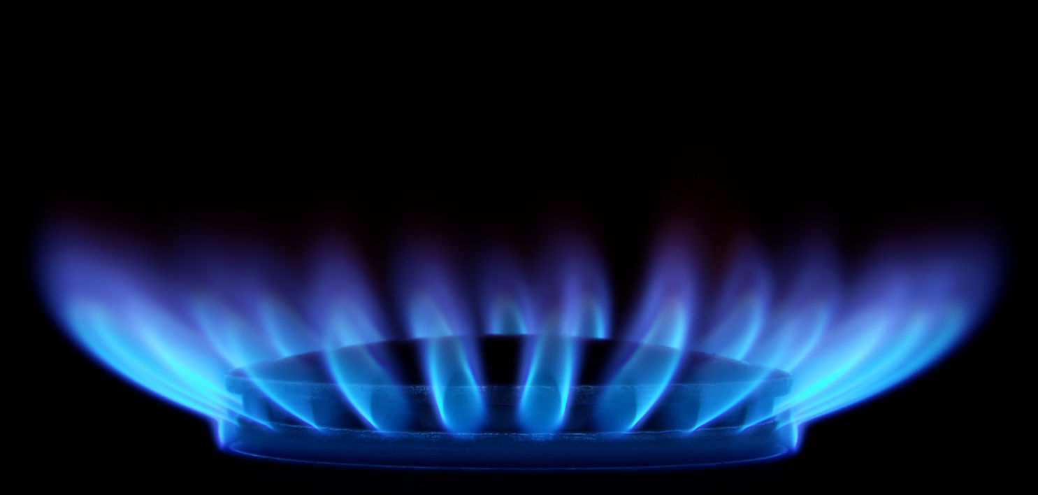 Blue flames of gas stove in the dark
