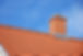 Close up view of red roof tiles installed on a pitched residential roof