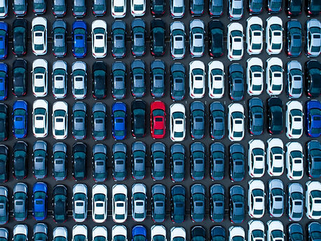 overhead view of dozens of cars of various colors