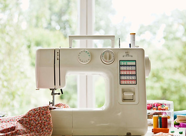 Sewing machine on table in front of window