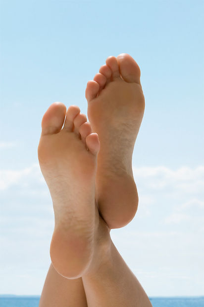 woman with clean bare feet crossed at the ankles resting comfortably