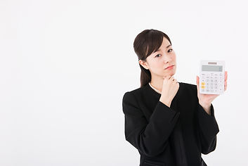 喪服で電卓を持つミドル女性