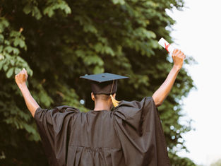 graduate celebrating outdoors