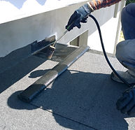 Roofer working on a flat roof