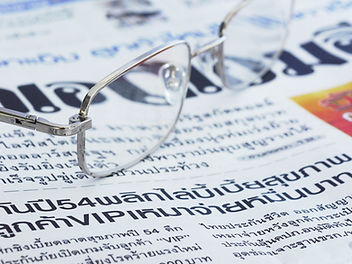 Eyeglasses on a newpaper