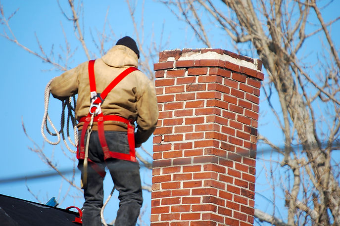"Chimney sweep at work. Focus is on chimney, not man. 500mm. Powerline runs through shot