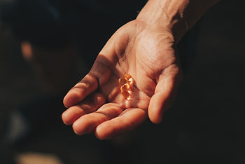 hand holding omega 3 supplements