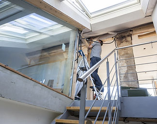 home Renovation in Progress. Tradesperson working on hallway stairs