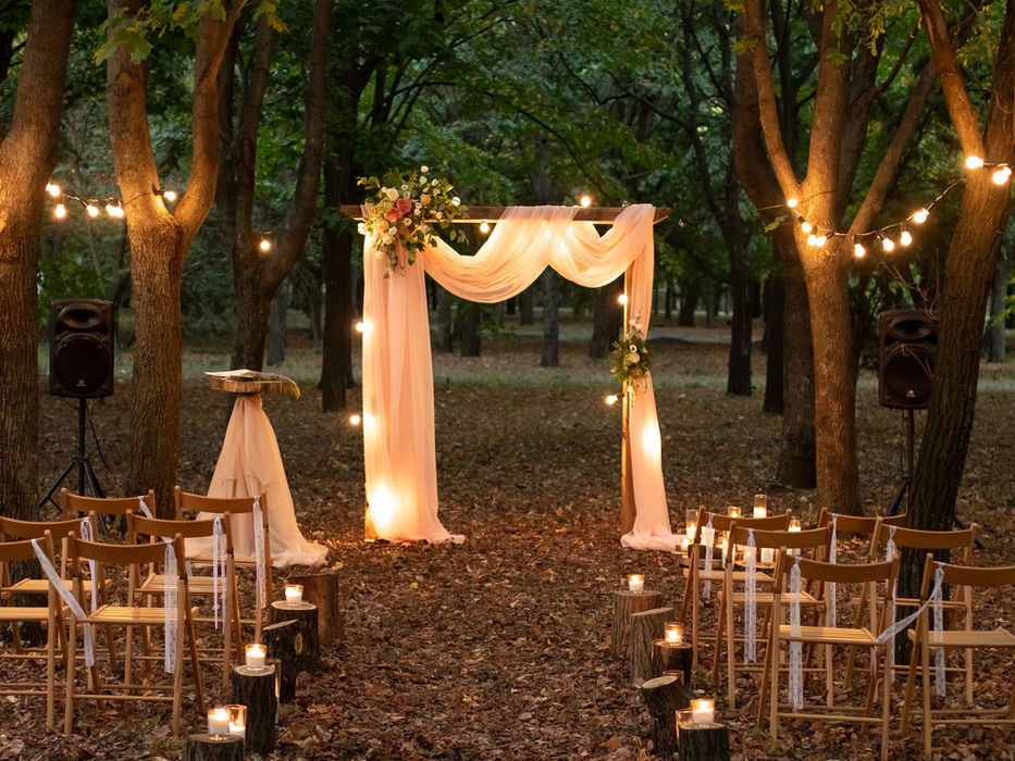Wedding ceremony setup at the estate with floral arch and seating.