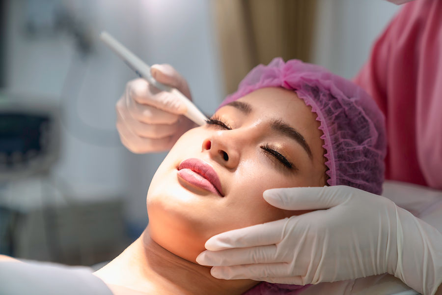 Portrait Of Young Woman with the beauty clinic backgrounds with receiving facial microderm