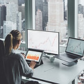 A woman at the office overlooking the city skyline
