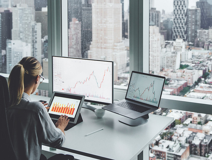 A woman at the office overlooking the city skyline