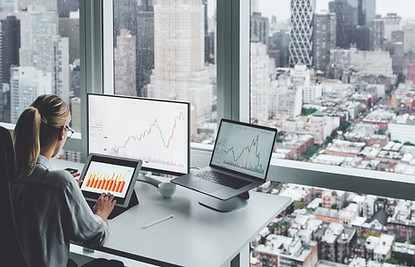 A woman at the office overlooking the city skyline