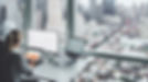 A woman at the office overlooking the city skyline