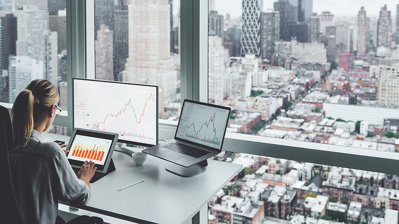 A woman at the office overlooking the city skyline