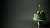 Green birthday cake with candle and macarons