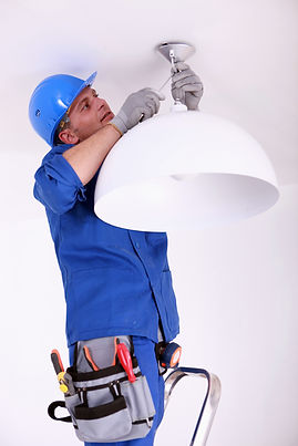 An electrical engineer repairing a decorative light