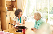 a care worker or medical professional or housing officer makes a house call to a senior