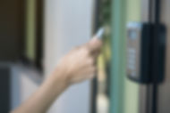 Young woman using RFID tag key to open the door
