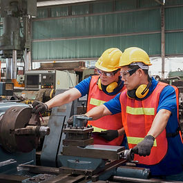 Two technicians working on the machine