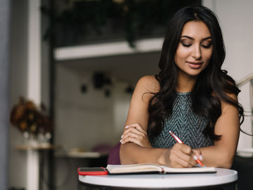 Woman making notes during post supervision reflection time