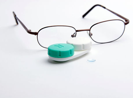Contact lenses with conventional eye glasses in the background