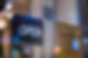 Close-Up Of Open Sign Hanging From Glass Window Of Store