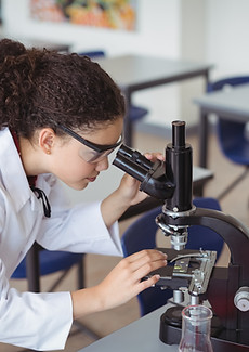 A Young Scientist looking through a microscope