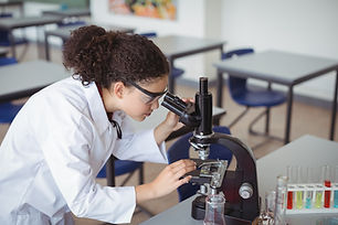 A Young Scientist looking through a micr