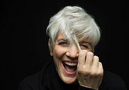 Senior woman laughing, showcasing renewed vitality after anti-aging treatment.