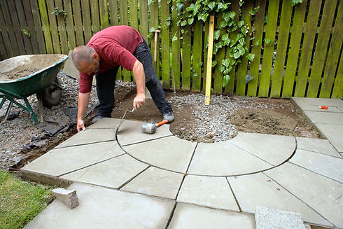A professional laying patio tiles