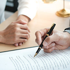 Legal counsel presenting a signed contract with gavel and legal documents