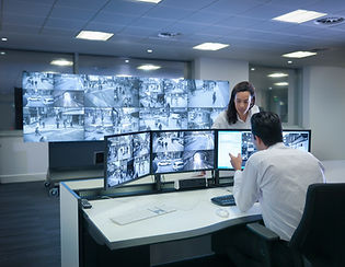 two persons and CCTV screens in control room