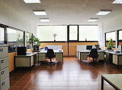 An empty office space with computers on desks